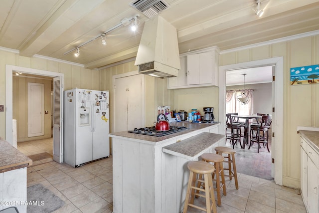 408 Section Ave, Rayne, LA 70578 - kitchen featuring white fridge with ice dispenser, stainless steel gas cooktop, custom range hood, crown molding, and light tile patterned floors