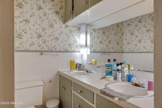 408 Section Ave, Rayne, LA 70578 - bathroom with wallpapered walls, double vanity, a wainscoted wall, and tile walls