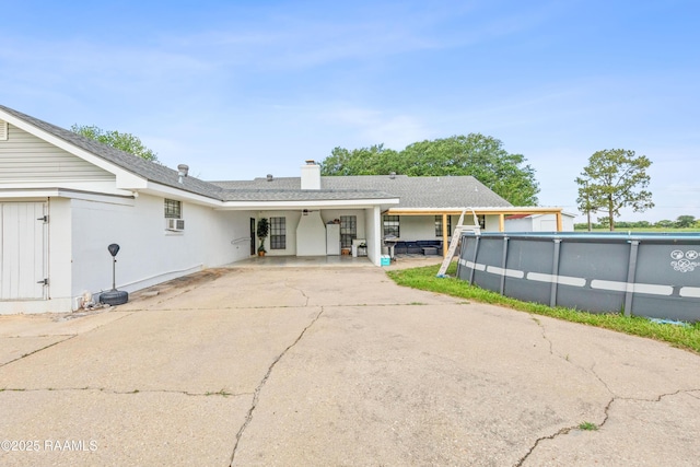 8001 Alpha Rd, Abbeville, LA 70510 - back of property with an outdoor pool and a chimney