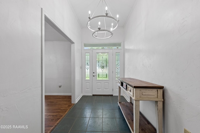 8001 Alpha Rd, Abbeville, LA 70510 - foyer with crown molding, a chandelier, and dark tile patterned floors