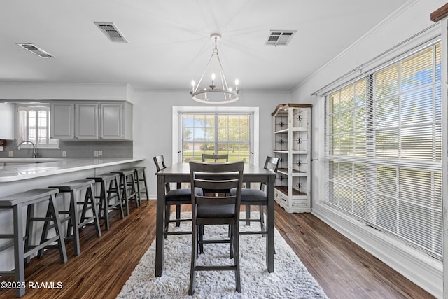 8001 Alpha Rd, Abbeville, LA 70510 - dining area with a chandelier, ornamental molding, and dark wood-style floors
