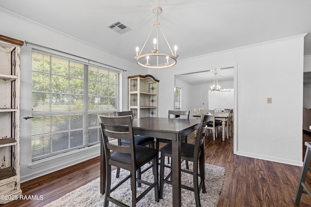 8001 Alpha Rd, Abbeville, LA 70510 - dining room with a chandelier, ornamental molding, wood finished floors, and baseboards