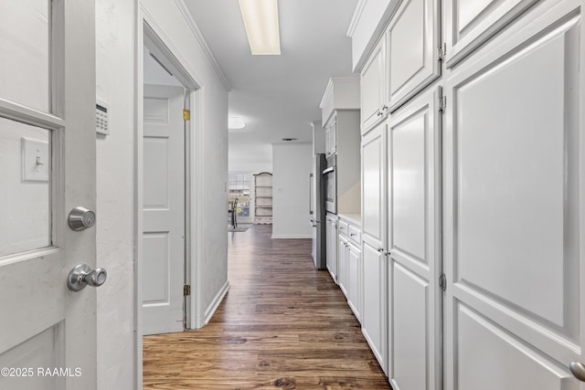 8001 Alpha Rd, Abbeville, LA 70510 - corridor featuring dark wood-style flooring and baseboards