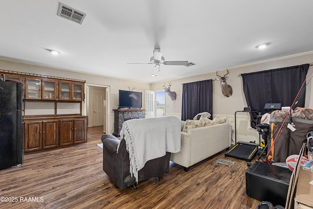 8001 Alpha Rd, Abbeville, LA 70510 - living room featuring ceiling fan, dark wood-type flooring, and crown molding