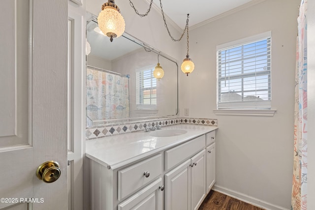 8001 Alpha Rd, Abbeville, LA 70510 - full bath with crown molding, vanity, wood finished floors, and baseboards