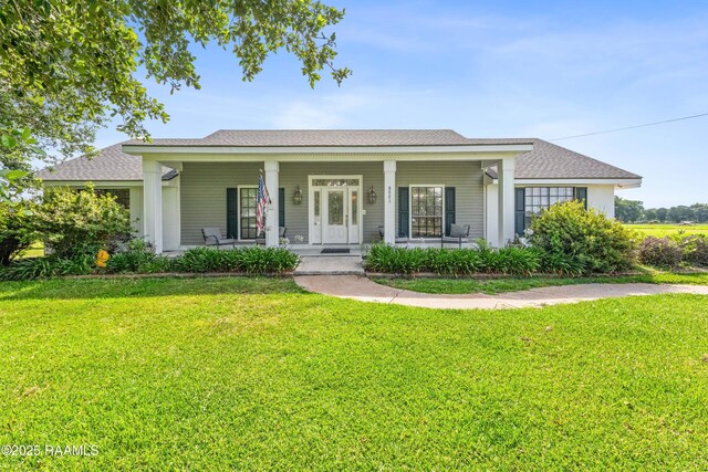 8001 Alpha Rd, Abbeville, LA 70510 - ranch-style house with covered porch and a front yard
