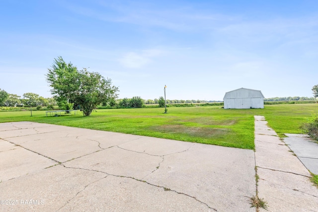 8001 Alpha Rd, Abbeville, LA 70510 - view of green lawn with an outdoor structure, a barn, and a garage