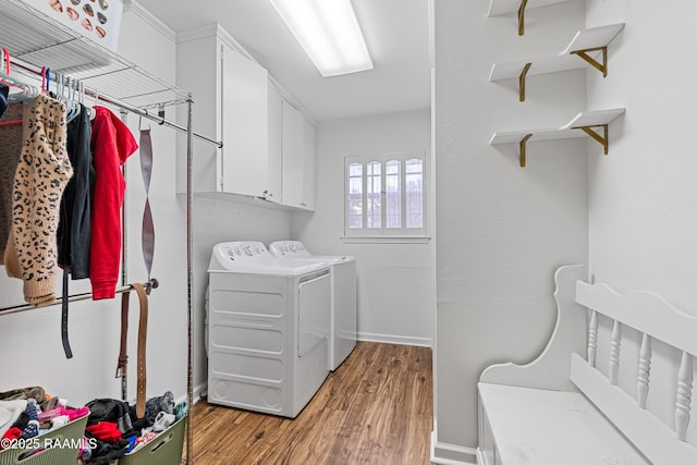 8001 Alpha Rd, Abbeville, LA 70510 - laundry area with cabinet space, light wood-type flooring, independent washer and dryer, and baseboards