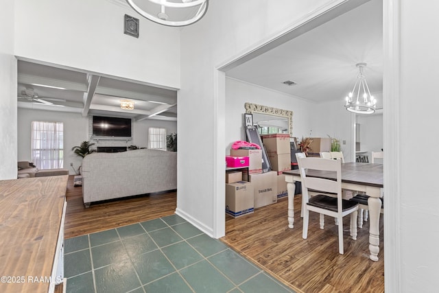 8001 Alpha Rd, Abbeville, LA 70510 - dining room with a chandelier, coffered ceiling, dark tile patterned floors, ceiling fan, and beam ceiling