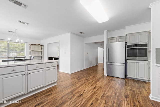 8001 Alpha Rd, Abbeville, LA 70510 - kitchen featuring stainless steel appliances, a chandelier, dark wood-type flooring, light countertops, and gray cabinetry
