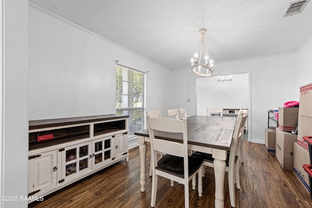 8001 Alpha Rd, Abbeville, LA 70510 - dining space with a chandelier, dark wood-type flooring, and ornamental molding