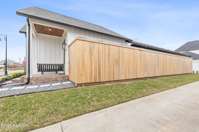 201 Lake Crest Ln, Youngsville, LA 70592 - view of side of property featuring a lawn and a shingled roof