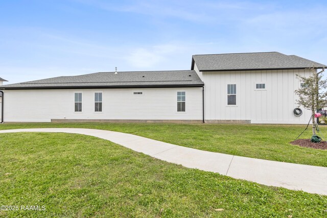 201 Lake Crest Ln, Youngsville, LA 70592 - back of house with a yard, board and batten siding, and roof with shingles
