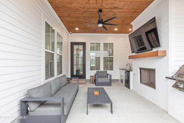 201 Lake Crest Ln, Youngsville, LA 70592 - view of patio / terrace featuring an outdoor living space with a fireplace, a ceiling fan, and a sink