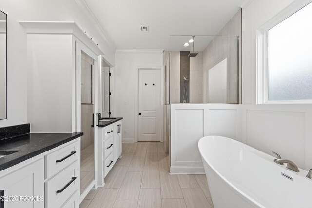 201 Lake Crest Ln, Youngsville, LA 70592 - bathroom featuring vanity, a walk in shower, a soaking tub, and ornamental molding