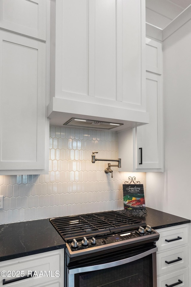 201 Lake Crest Ln, Youngsville, LA 70592 - kitchen featuring gas range, white cabinetry, and tasteful backsplash