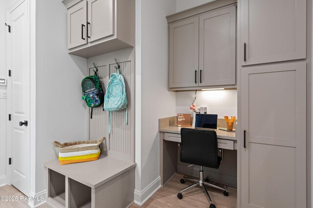 201 Lake Crest Ln, Youngsville, LA 70592 - office area featuring baseboards, built in desk, and light wood-style floors