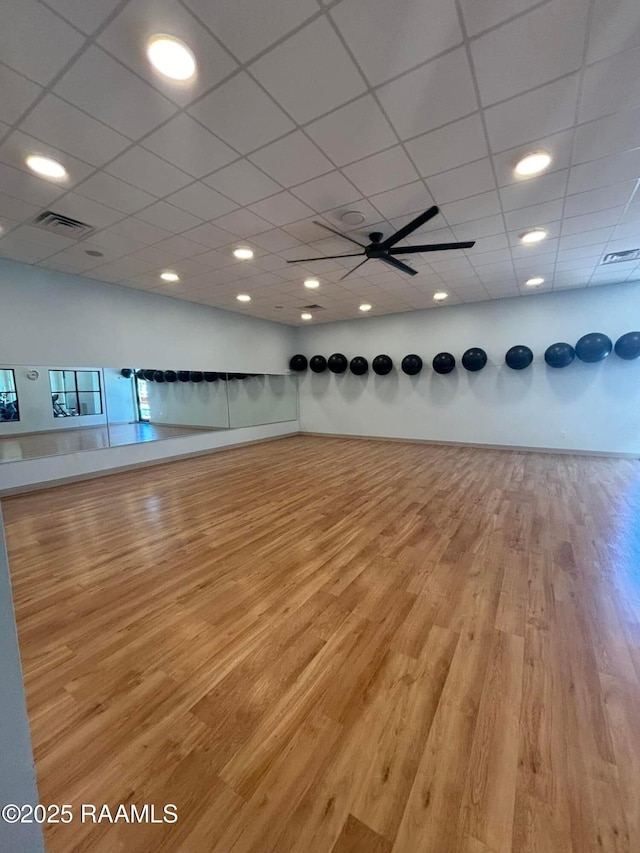 201 Lake Crest Ln, Youngsville, LA 70592 - exercise area with wood finished floors, a paneled ceiling, and baseboards