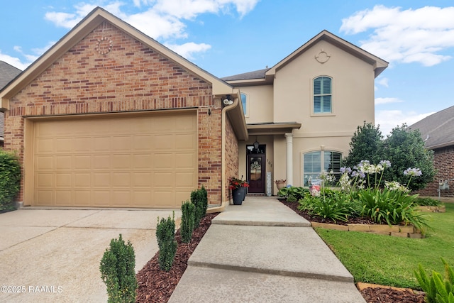 107 Ace Ln, Lafayette, LA 70506 - view of front of property featuring concrete driveway, a garage, brick siding, and stucco siding