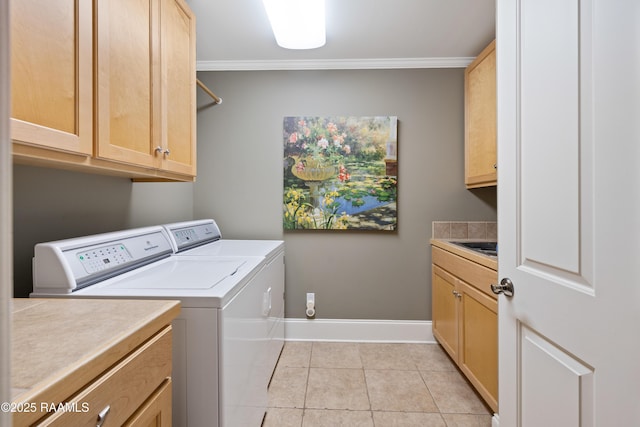 2822 Teal Dr, New Iberia, LA 70560 - laundry room with washer and clothes dryer, cabinet space, light tile patterned flooring, and ornamental molding