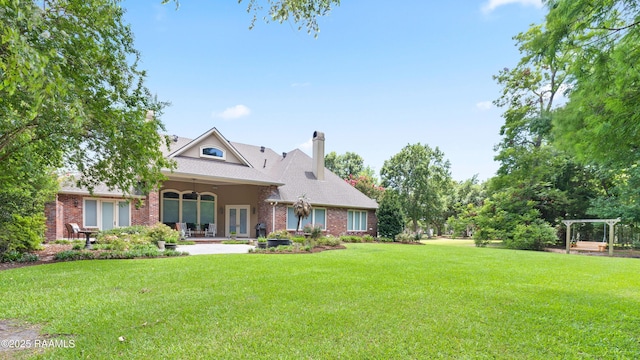 2822 Teal Dr, New Iberia, LA 70560 - rear view of house with a chimney, brick siding, a yard, and a patio area