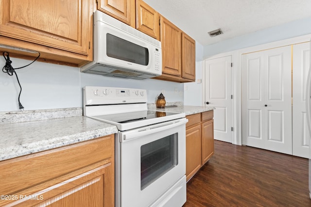 100 Winchester Dr Unit 308, Lafayette, LA 70506 - kitchen with white appliances, dark wood-style floors, and light stone counters