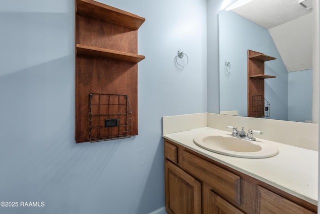 100 Winchester Dr Unit 308, Lafayette, LA 70506 - bathroom featuring vanity, vaulted ceiling, and baseboards