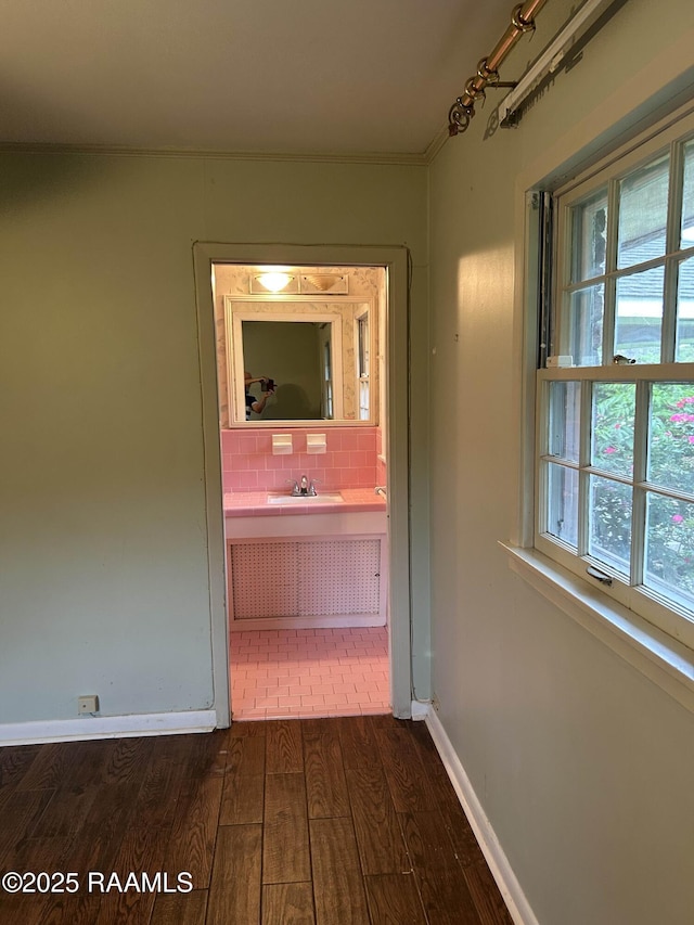 500 Brentwood Blvd, Lafayette, LA 70503 - hall featuring dark wood-type flooring, plenty of natural light, baseboards, crown molding, and a sink