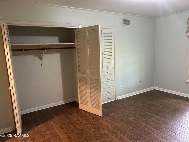 500 Brentwood Blvd, Lafayette, LA 70503 - unfurnished bedroom featuring crown molding, dark wood-type flooring, a closet, and baseboards