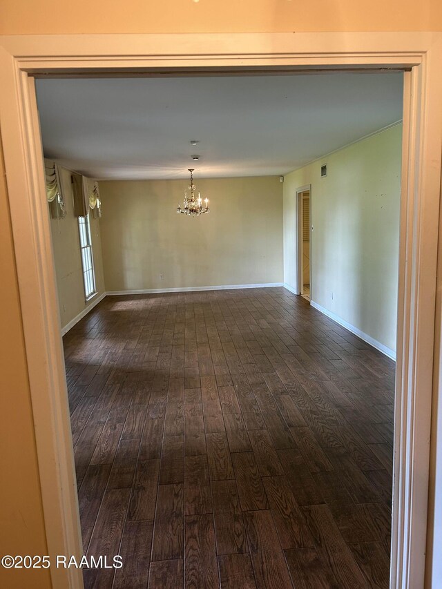 500 Brentwood Blvd, Lafayette, LA 70503 - empty room featuring dark wood-type flooring, a chandelier, and baseboards