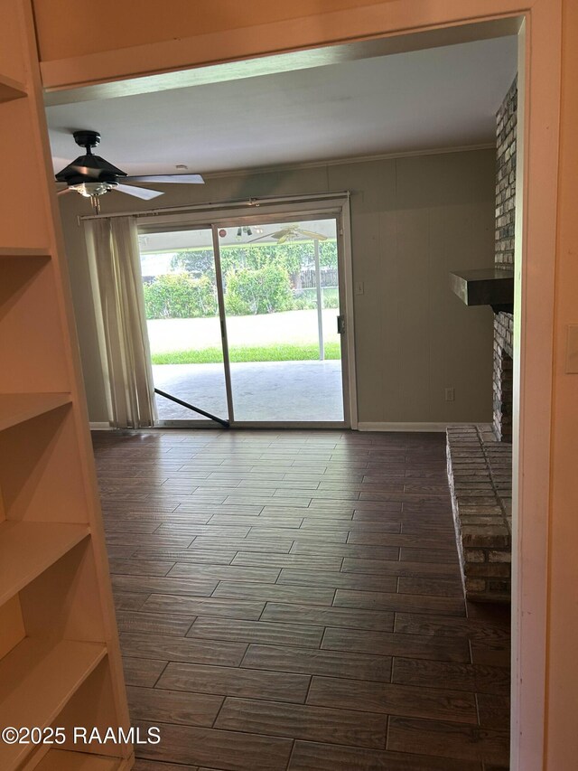 500 Brentwood Blvd, Lafayette, LA 70503 - spare room featuring a ceiling fan, a fireplace, dark wood-type flooring, and baseboards