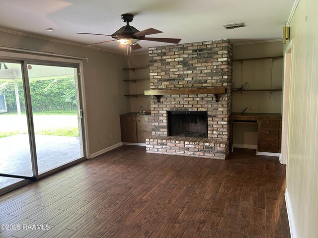 500 Brentwood Blvd, Lafayette, LA 70503 - unfurnished living room featuring wood finished floors, a ceiling fan, ornamental molding, a brick fireplace, and baseboards