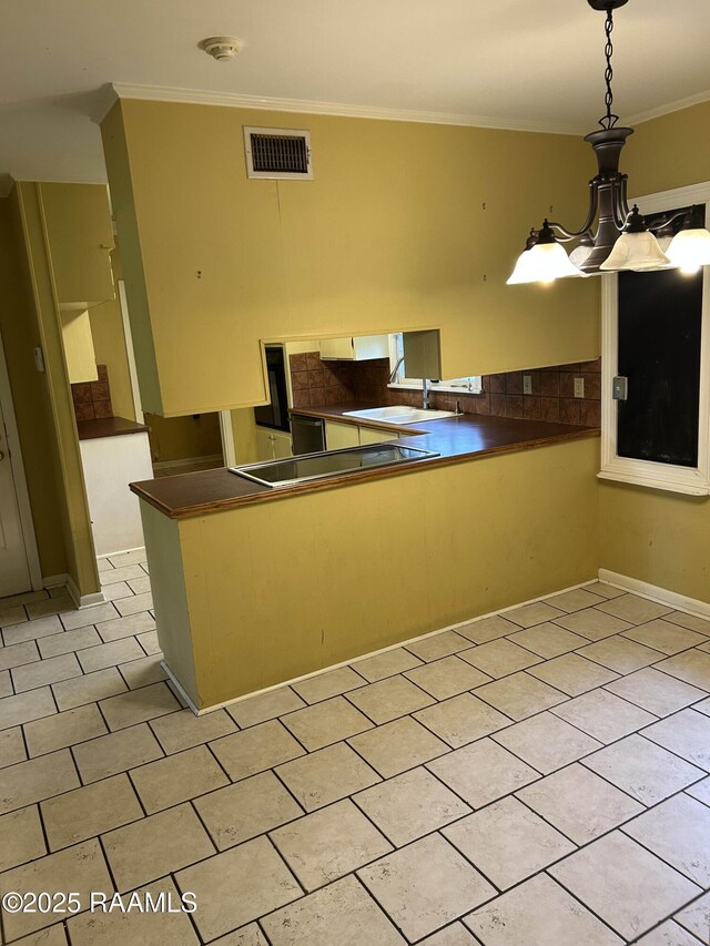 500 Brentwood Blvd, Lafayette, LA 70503 - kitchen with ornamental molding, dark countertops, black electric cooktop, hanging light fixtures, and a sink