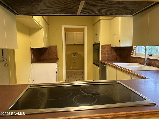 500 Brentwood Blvd, Lafayette, LA 70503 - kitchen with a sink, black appliances, tasteful backsplash, and white cabinets