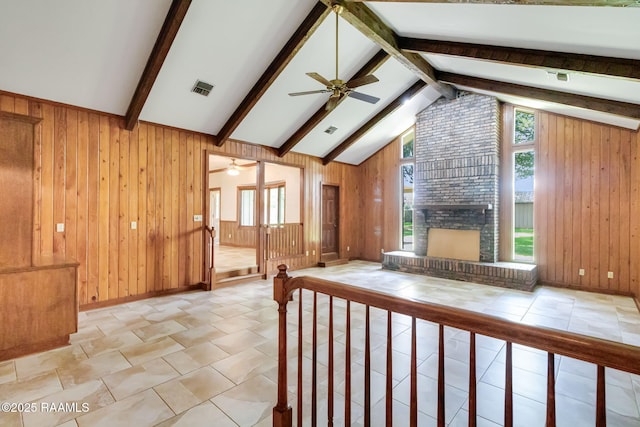 505 Herbert Rd, Lafayette, LA 70506 - living room featuring a ceiling fan, wood walls, a brick fireplace, and tile patterned floors