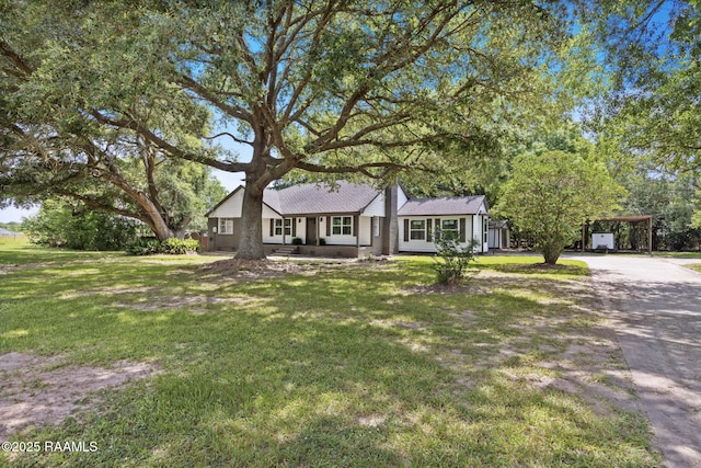 178 Bertrand Rd, Opelousas, LA 70570 - ranch-style house with a front yard, a detached carport, and driveway