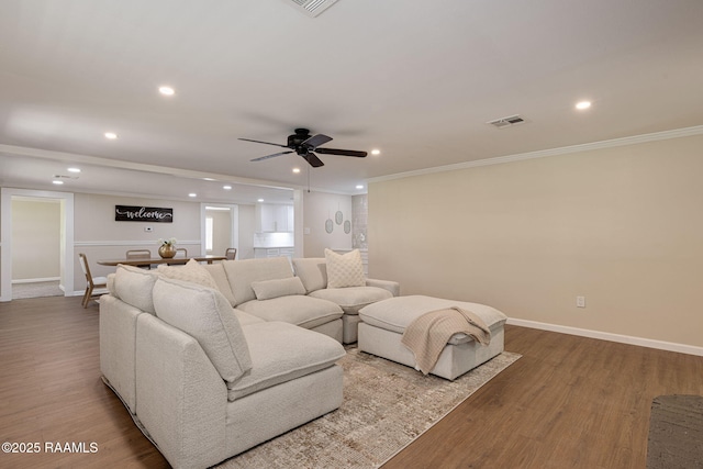 178 Bertrand Rd, Opelousas, LA 70570 - living area featuring wood finished floors, baseboards, crown molding, a ceiling fan, and recessed lighting