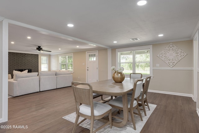 178 Bertrand Rd, Opelousas, LA 70570 - dining space featuring baseboards, ornamental molding, recessed lighting, wood finished floors, and a brick fireplace