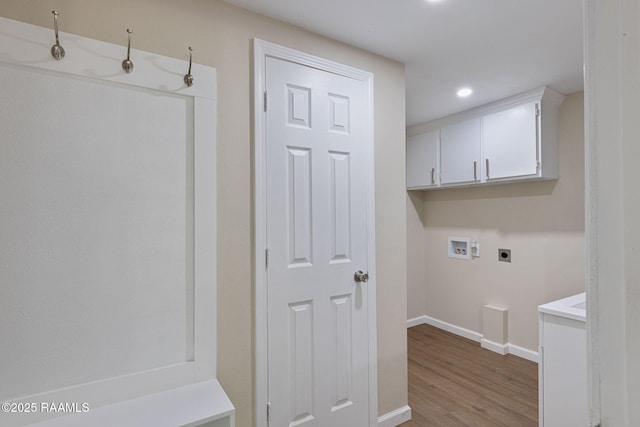 178 Bertrand Rd, Opelousas, LA 70570 - laundry area featuring electric dryer hookup, hookup for a washing machine, cabinet space, baseboards, and wood finished floors