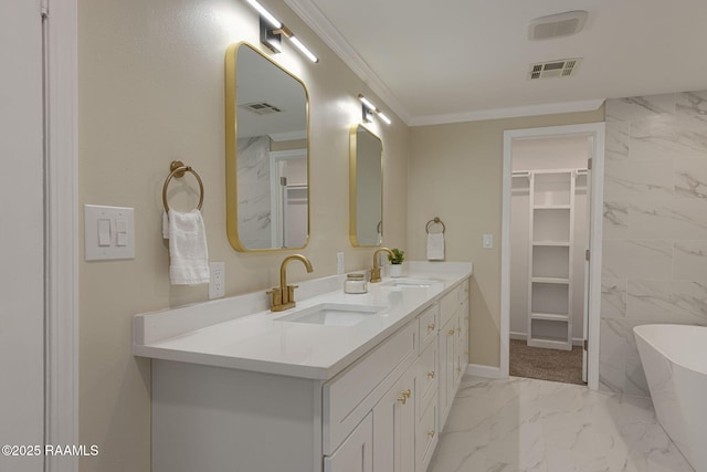 178 Bertrand Rd, Opelousas, LA 70570 - full bathroom featuring marble look tile flooring, double vanity, a soaking tub, a spacious closet, and ornamental molding