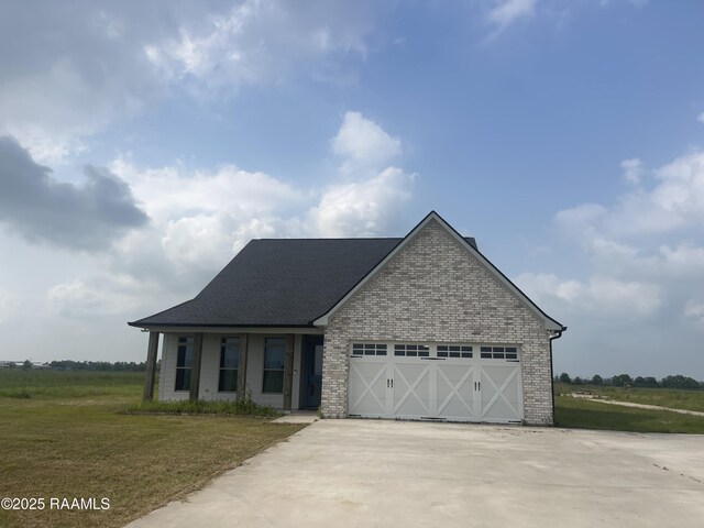 5087 Natali Rd, Lake Charles, LA 70607 - view of front of house featuring concrete driveway, a garage, a shingled roof, a front lawn, and brick siding