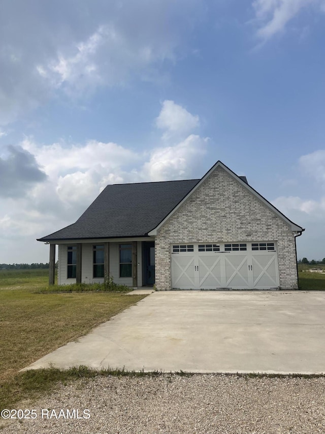 5087 Natali Rd, Lake Charles, LA 70607 - view of front of house featuring driveway, a front yard, an attached garage, and a shingled roof