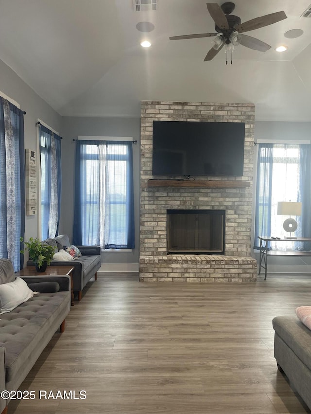 5087 Natali Rd, Lake Charles, LA 70607 - living room featuring vaulted ceiling, wood finished floors, healthy amount of natural light, ceiling fan, and a fireplace