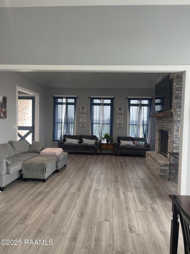5087 Natali Rd, Lake Charles, LA 70607 - living area featuring light wood finished floors and a brick fireplace
