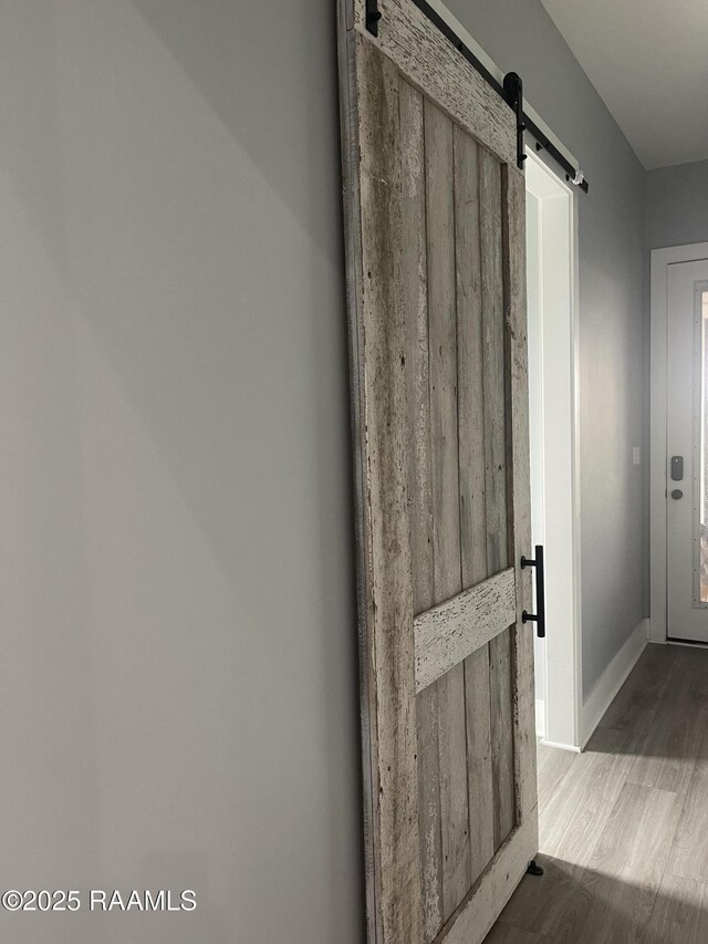 5087 Natali Rd, Lake Charles, LA 70607 - detailed view of a barn door, wood finished floors, and baseboards