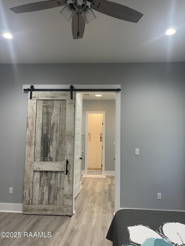 5087 Natali Rd, Lake Charles, LA 70607 - bedroom featuring a barn door, wood finished floors, baseboards, recessed lighting, and a ceiling fan
