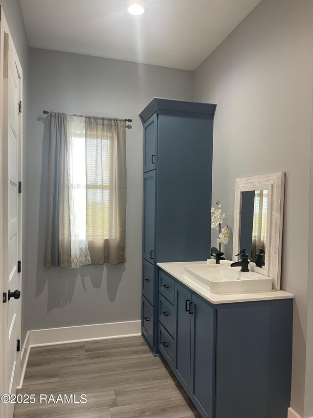 5087 Natali Rd, Lake Charles, LA 70607 - bathroom with vanity, wood finished floors, baseboards, and recessed lighting