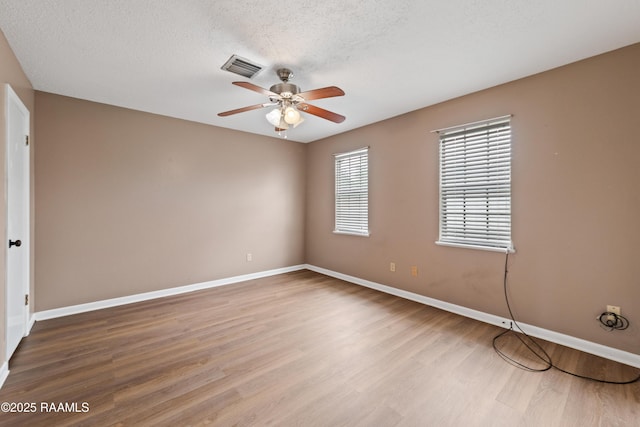 221 Timothy Dr, Lafayette, LA 70503 - unfurnished room with a ceiling fan, wood finished floors, baseboards, and a textured ceiling