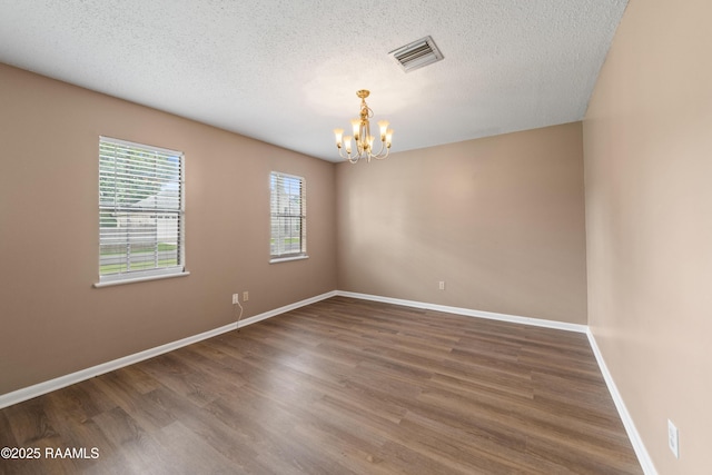221 Timothy Dr, Lafayette, LA 70503 - unfurnished room featuring a chandelier, wood finished floors, a textured ceiling, and baseboards