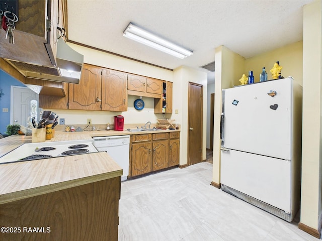 106 Cheticamp Dr, Lafayette, LA 70508 - kitchen featuring white appliances, brown cabinets, and a textured ceiling